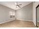 Sunlit bedroom featuring wood-look floors, ceiling fan and closet at 10417 E Champagne Dr, Sun Lakes, AZ 85248