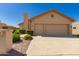Charming single-story home with a two-car garage, desert landscaping, and a tile roof at 10417 E Champagne Dr, Sun Lakes, AZ 85248