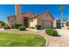 Charming single-story home with lush green lawn and mature landscaping at 10417 E Champagne Dr, Sun Lakes, AZ 85248