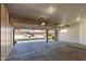 Spacious garage with storage cabinets, providing ample space for vehicles and storage at 10417 E Champagne Dr, Sun Lakes, AZ 85248