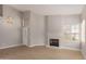 Inviting living area with fireplace, stylish chandelier, and neutral color palette at 10417 E Champagne Dr, Sun Lakes, AZ 85248