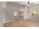 Light-filled primary bedroom features a ceiling fan, mirrored closet doors, and windows for a relaxing atmosphere at 10417 E Champagne Dr, Sun Lakes, AZ 85248