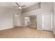 Spacious primary bedroom with a ceiling fan and a mirrored closet provides a comfortable retreat at 10417 E Champagne Dr, Sun Lakes, AZ 85248