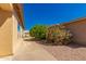 Landscaped side yard features well-maintained plants and a concrete walkway under a clear blue sky at 10417 E Champagne Dr, Sun Lakes, AZ 85248