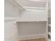 Organized walk-in closet with shelving and hanging space provides storage solutions for clothing and accessories at 10417 E Champagne Dr, Sun Lakes, AZ 85248