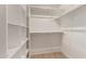 Well-organized walk-in closet offers ample storage space with shelves and hanging rods for convenience at 10417 E Champagne Dr, Sun Lakes, AZ 85248