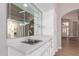A built-in wet bar with glass shelving and a sink enhances the home's entertaining capabilities at 10417 E Champagne Dr, Sun Lakes, AZ 85248