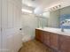 Bathroom with double sinks, a shower, and wood cabinets at 10958 E Secret Mine Ct, Gold Canyon, AZ 85118