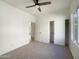 Bright bedroom with ceiling fan and carpet at 10958 E Secret Mine Ct, Gold Canyon, AZ 85118