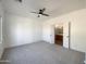 Bright and airy bedroom with carpeted floors and double doors at 10958 E Secret Mine Ct, Gold Canyon, AZ 85118