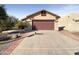 House exterior with a two-car garage and a well-maintained front yard at 10958 E Secret Mine Ct, Gold Canyon, AZ 85118