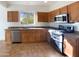 Kitchen with wood cabinets, stainless steel appliances, and tile flooring at 10958 E Secret Mine Ct, Gold Canyon, AZ 85118