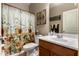 Bathroom with sunflower shower curtain and wood vanity at 1157 E Daisy Way, San Tan Valley, AZ 85143