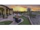 Covered patio, firepit, and artificial turf at 12128 W Desert Mirage Dr, Peoria, AZ 85383