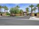 Gated community entrance with arched entryway and palm trees at 12128 W Desert Mirage Dr, Peoria, AZ 85383