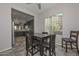 Bright dining area with dark wood table and chairs, adjacent to kitchen at 12128 W Desert Mirage Dr, Peoria, AZ 85383