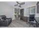 Home office features built-in shelving and comfortable seating at 12128 W Desert Mirage Dr, Peoria, AZ 85383