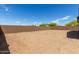 Wide backyard view, featuring a brick wall and an open space ready for landscaping at 12358 W Marguerite Ave, Avondale, AZ 85323