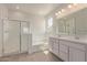 Bright bathroom features a large vanity, soaking tub and glass shower enclosure at 12358 W Marguerite Ave, Avondale, AZ 85323