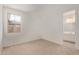 Carpeted bedroom with a window and view into the adjacent bathroom at 12358 W Marguerite Ave, Avondale, AZ 85323
