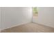 Bright bedroom with a neutral carpet and a window letting in natural light at 12358 W Marguerite Ave, Avondale, AZ 85323