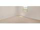 This bright bedroom features neutral carpet, and a window with natural light at 12358 W Marguerite Ave, Avondale, AZ 85323