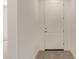 Clean entryway with wood-look tile floors and a white door at 12358 W Marguerite Ave, Avondale, AZ 85323