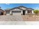 Charming single-story home with a three-car garage, desert landscaping, and a welcoming facade at 12358 W Marguerite Ave, Avondale, AZ 85323