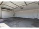 Spacious garage with concrete floors and two garage doors, offering ample parking at 12358 W Marguerite Ave, Avondale, AZ 85323