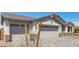 A three car garage door exterior with gray brick accents at 12358 W Marguerite Ave, Avondale, AZ 85323