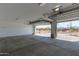 Spacious garage featuring two car doors and a view to the exterior at 12358 W Marguerite Ave, Avondale, AZ 85323