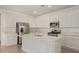 Modern kitchen with white cabinetry, a center island, and stainless steel appliances at 12358 W Marguerite Ave, Avondale, AZ 85323