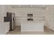 Bright kitchen with white cabinets, stainless steel appliances, and a center island at 12358 W Marguerite Ave, Avondale, AZ 85323