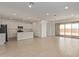 Open concept living space with kitchen, dining, and living areas featuring tile floors at 12358 W Marguerite Ave, Avondale, AZ 85323