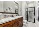 Stylish bathroom featuring a double vanity and walk-in shower at 1321 N 102Nd St, Mesa, AZ 85207