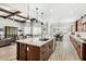 Open concept kitchen with island, hardwood floors, and a view into the living room at 1321 N 102Nd St, Mesa, AZ 85207