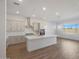 Modern kitchen with light gray cabinets, quartz island, and stainless steel appliances at 13528 W Phacelia Ln, Peoria, AZ 85383