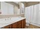 Bathroom with double sinks and wood cabinets at 146 N Parkview Ln, Litchfield Park, AZ 85340