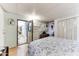 Spacious bedroom with floral bedding and access to the bathroom at 17200 W Bell Rd # 641, Surprise, AZ 85374