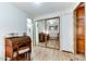 Bright hallway with mirrored closet doors and hardwood floors at 17200 W Bell Rd # 641, Surprise, AZ 85374