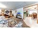 Living room with floral couch and view into the kitchen at 17200 W Bell Rd # 641, Surprise, AZ 85374