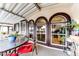 Covered patio with glass-top table and red chairs at 17200 W Bell Rd # 641, Surprise, AZ 85374