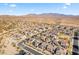 Wide aerial view of a residential community nestled in a scenic desert landscape at 17755 W Jojoba Rd, Goodyear, AZ 85338