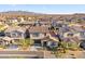 Aerial view of a house in a residential neighborhood with mountains in the background at 17755 W Jojoba Rd, Goodyear, AZ 85338