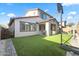 Artificial turf backyard with patio and basketball hoop at 17755 W Jojoba Rd, Goodyear, AZ 85338