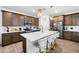 Modern kitchen with island and white quartz countertops at 17755 W Jojoba Rd, Goodyear, AZ 85338