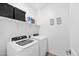 Bright laundry room with washer, dryer, and shelving at 17755 W Jojoba Rd, Goodyear, AZ 85338