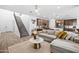 Open concept living room and kitchen with grey sectional at 17755 W Jojoba Rd, Goodyear, AZ 85338