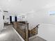 Upstairs hallway with wooden railing and carpeted stairs at 17755 W Jojoba Rd, Goodyear, AZ 85338