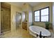 Primary bathroom featuring soaking tub and walk-in shower at 1777 W Ocotillo Rd # 2, Chandler, AZ 85248